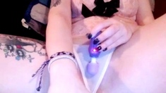 Brunette enjoys the toy on gaping pussy while masturbating
