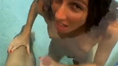 Funny handjob inside swimming pool