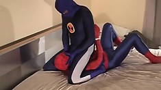 Guy dressed in a Spider-man costume gets tied down and teased